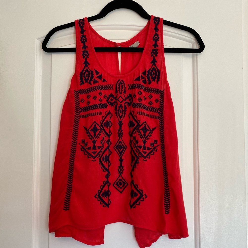 Red top with navy embroidery and open back